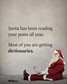 photo of Santa sitting on the floor with an open laptop: Santa has been reading your posts all year. Most of you are getting dictionaries.