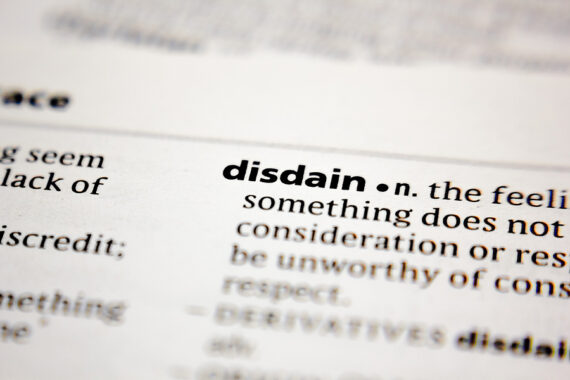pagea of dictionary explasining meaning of the word disdain